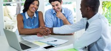 happy-couple-shaking-hands-with-real-estate-agent-ENP3UQ9